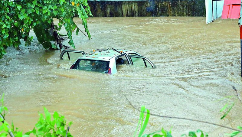 A fully-submerged car at Edappally in Kochi on Thursday as rains battered the city for the second day in succession. (Image: PTI, ARUN CHANDRABOSE)