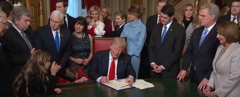 Donald Trump signing his first documents as the US President. (Photo: YouTube screengrab)