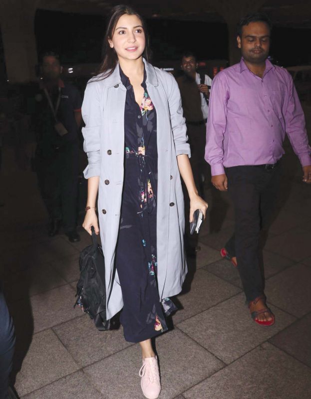 Anushka Sharma has paired her floral dress with an oversized trench coat.