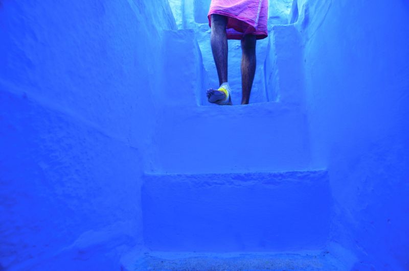 A man descends the steps in his home during the morning of Diwali in Jodhpur, the Blue City, India.