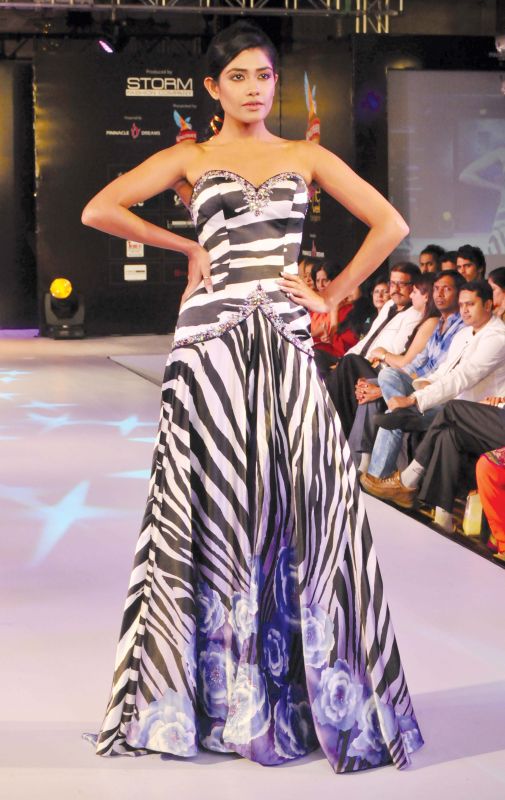 The model is seen wearing a zebra printed gown.