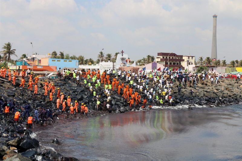 Coast Guard, State revenue personnel, local volunteers, and fishermen removing black oil washed ashore as a thick oily tide from the sea lapped at the coast. (Photo: PTI)