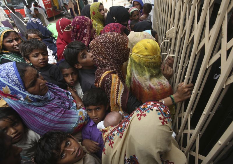 Pakistani villagers wait outside a hospital for blood screening for HIV at a hospital in a village near Ratodero, a small town in southern province of Sindh in Pakistan where the outbreak of deadly disease took place last month, Thursday, May 16, 2019. Officials say about 500 people, mostly children, have tested positive for HIV, the virus that causes AIDS, in a southern Pakistani provincial district. A local doctor who has AIDS has since been arrested and is being investigated for possibly intentionally infecting patients. (AP Photo/Fareed Khan)