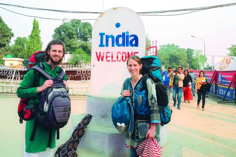 The travel enthusiasts pose for a picture as they enter India