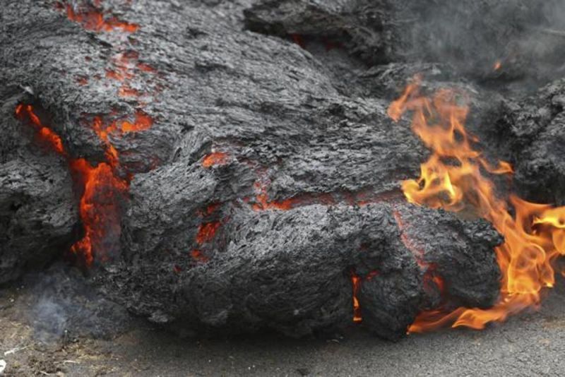 Lava burns across a road in the Leilani Estates subdivision, near Pahoa, Hawaii. (Photo: AP)