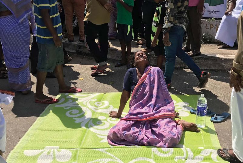 Mother of Jose, who is still missing in the sea, is all tears as she takes part in the road blockade at Chakka junction on Sunday. 