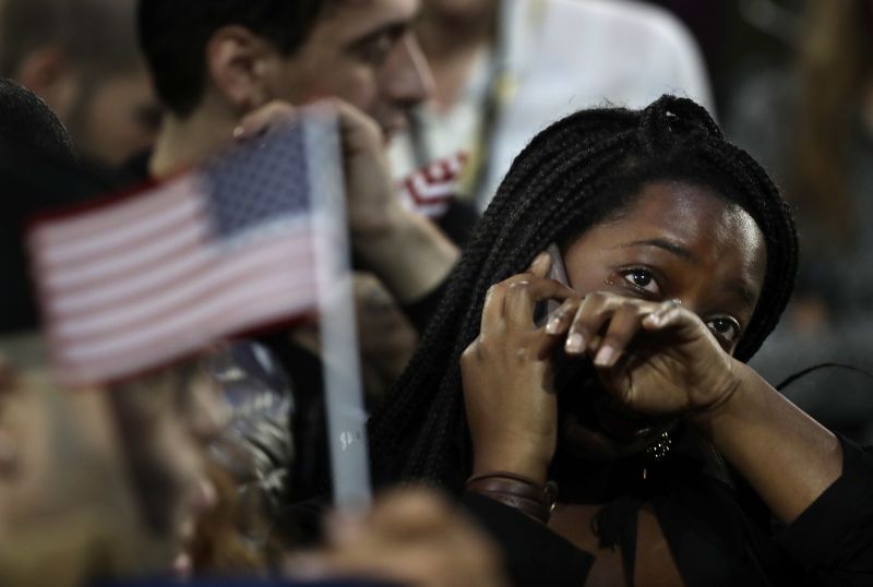 A woman weeps as election results are reported during Democratic presidential nominee Hillary Clinton's election night rally in the Jacob Javits Center glass enclosed lobby in New York.