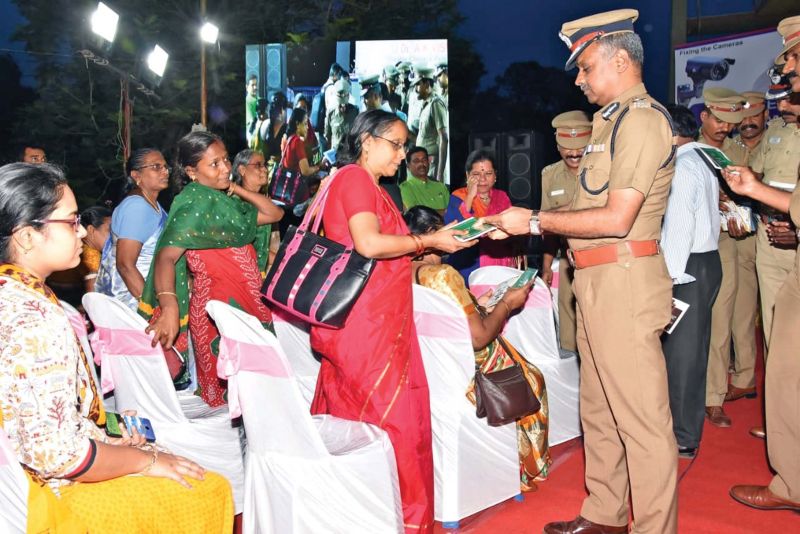 City police commissioner A.K. Viswanathan hands over awareness pamphlets to a resident during CCTV awareness programme in Anna Nagar recently.(Photo:DC)