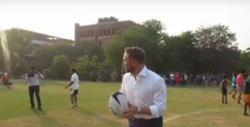 McCullum showing some of the local players how to throw a spiral ball.