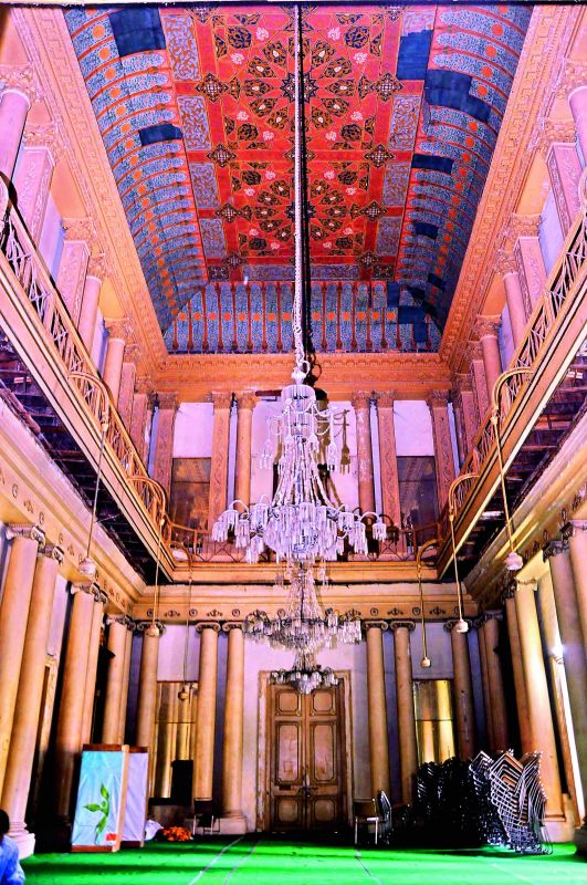 An internal view of Darbar Hall which has  painted ceilings and parquet floors of inlaid wood flanked by tall mirrors. 