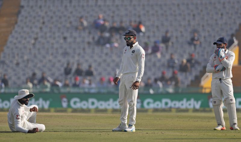 Virat Kohli did not look pleased as Ravindra Jadeja dropped Alastair Cook in the third over of the match. (Photo: AP)