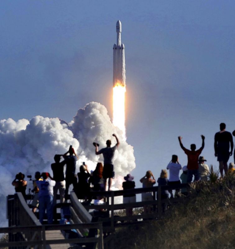 The crowd cheers at Playalinda Beach in the Canaveral National Seashore, just north of the Kennedy Space Center, during the successful launch of the SpaceX Falcon Heavy rocket. Playalinda is one of closest public viewing spots to see the launch, about 3 miles from the SpaceX launchpad 39A.