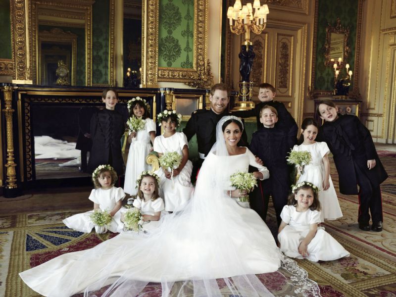 In this photo released by Kensington Palace on Monday May 21, 2018, shows an official wedding photo of Britain's Prince Harry and Meghan Markle, center, in Windsor Castle, Windsor, England, Saturday May 19, 2018. Others in photo from left, back row, Brian Mulroney, Remi Litt, Rylan Litt, Jasper Dyer, Prince George, Ivy Mulroney, John Mulroney; front row, Zalie Warren, Princess Charlotte, Florence van Cutsem. 