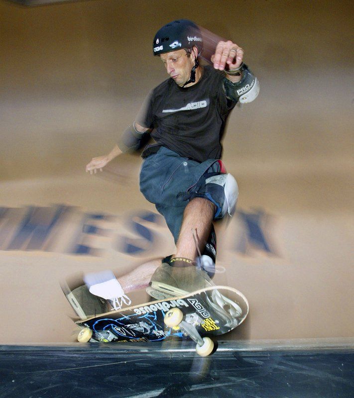 Tony Hawk of Carlsbad, Calif. slides a rail during the X-Games - skateboard vert practice held at the Staples Center in Los Angeles. eave it to Tony Hawk to mix a decades-old skateboarding trick with the latest in virtual reality technology. The 50-year-old skateboarding pioneer and entrepreneur is dragging his 360-degree loop ramp out of storage and giving a handful of young skaters the chance to try to nail the near-impossible trick on a live virtual reality broadcast Sunday afternoon, Aug. 26, 2018 from his corporate headquarters in northern San Diego County. (AP Photo/Chris Polk, File)