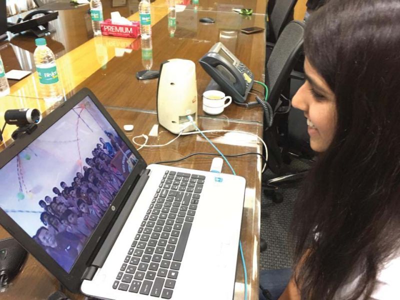 A volunteer teaches rural schoolchildren using Skype