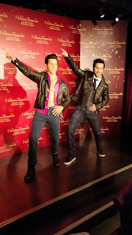 Varun Dhawan posing with his staue.