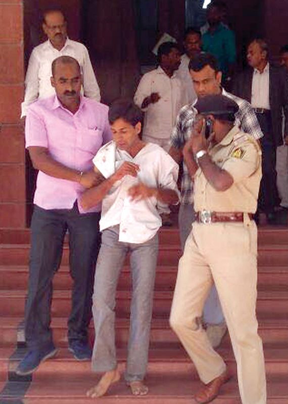 The 33-year-old attacker Tejraj in police custody at Lokayukta's office, in Bengaluru  on Wednesday. (Photo: DC)