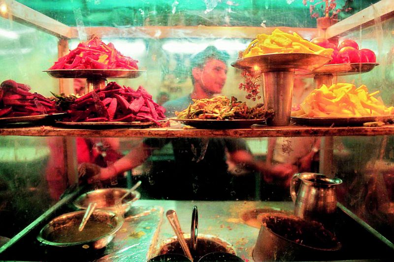 A young man seen through the window at Paratha Walli Gulli, one of the most famous places for parathas in old Delhi's Chandni Chowk. 