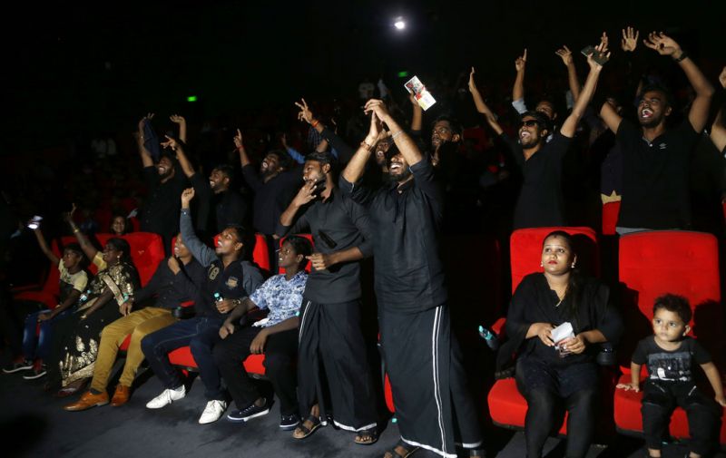 Spectators watch 'Kaala', the new film of superstar Rajinikanth in Mumbai. (Photo: AP)