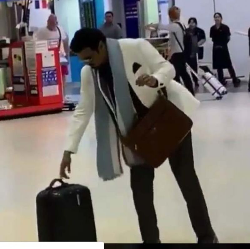 The video shows him in an airport, and the actor is seen shoving his suitcase away from him.