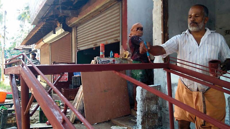 Putting the unexpected holiday to good use, a shop owner in Chengottukave near Koyilandy paints his furniture on Monday.  	(Photo: Venugopal)