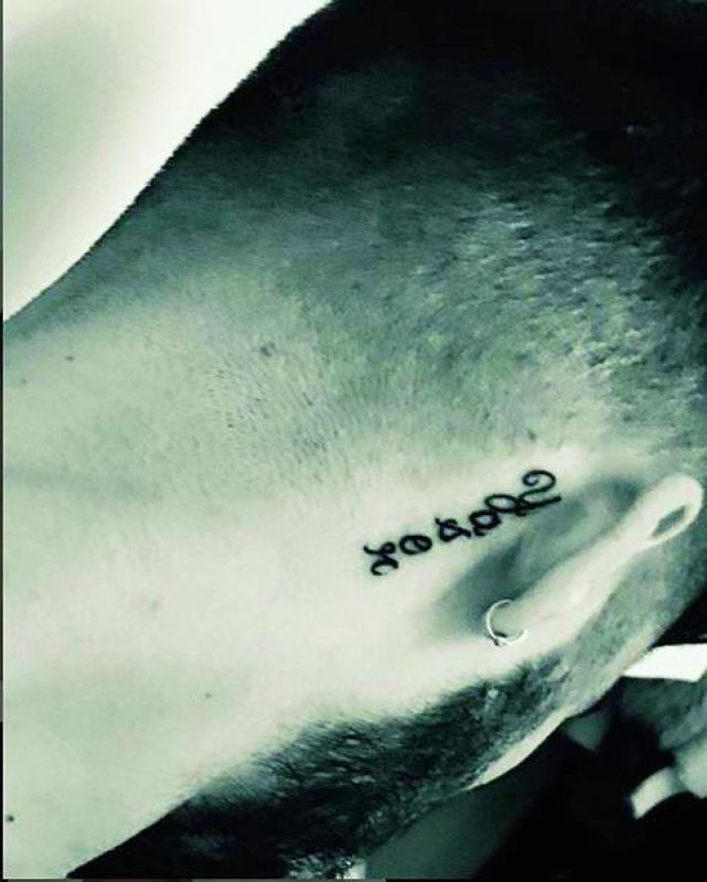 Daddy's boy: Zayn Malik got his father's name inked behind his right ear.