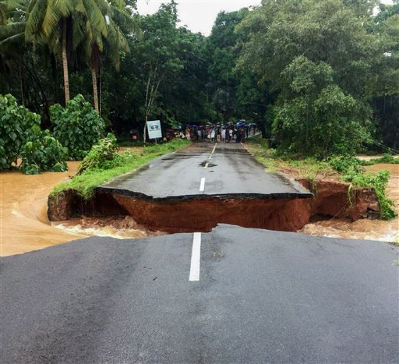Malappuram: A section of Nilambur- Karad road is seen washed away following a flash flood, triggered by heavy rains, at Malappuram in Kerala. (Photo: PTI)