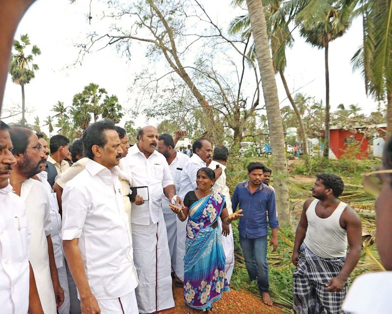 DMK president M.K Stalin, accompanied by party seniors, toured the Gaja-hit areas in interior Thanjavur and Pudukottai districts on Thursday. Picture shows him consoling a woman who has lost everything in the cyclone in a village. (Photo: DC)