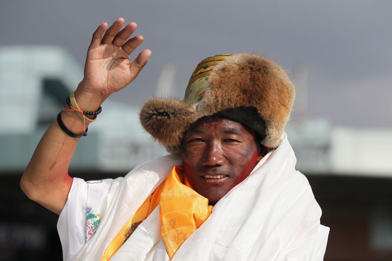 Nepalese veteran Sherpa guide, Kami Rita, 48, waves as he arrives in Kathmandu, Nepal. Rita has scaled Mount Everest for a 23rd time, breaking his own record for the most successful ascents of the world's highest peak. (Photo:AP)