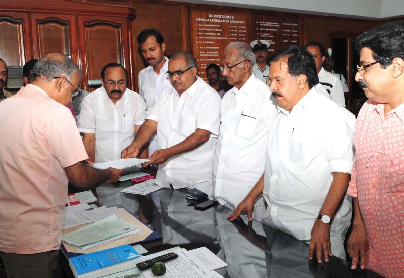 UDF candidate B. Babu Prasad hands over the nomination papers.  	
