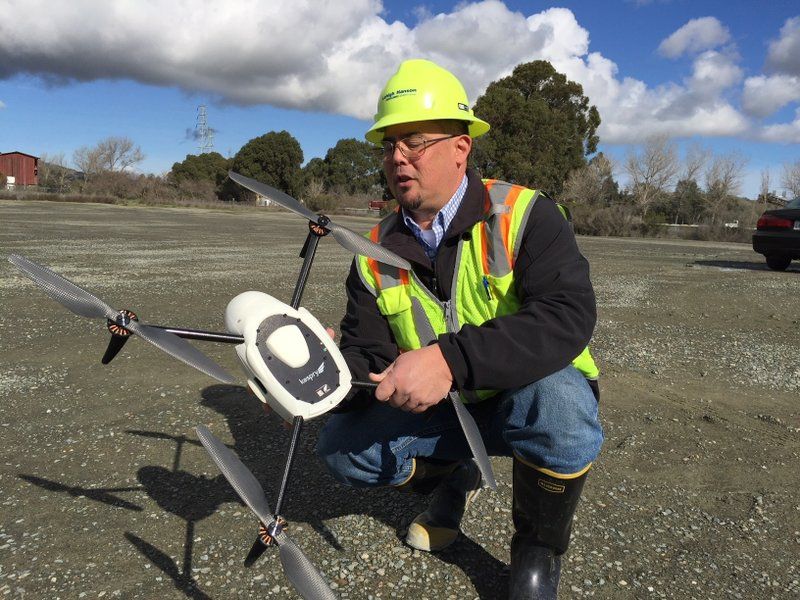 Mike Moy, an assistant plant manager for Lehigh Hanson Cement Group, inspects a Kespry drone he uses to survey inventories of rock, sand and other building materials at a mining plant in Sunol, California.