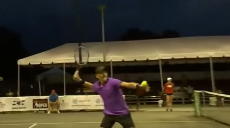 One of the two bemused American players, Mitchell Krueger, whacked a tennis ball far out of bounds toward the source of the racket, which the TV commentator said came from a nearby apartment. (Photo: Screengrab)