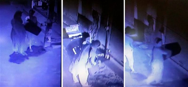 In a screengrab from a CCTV camera with a view of the entrance of the Chundawat house is seen members of the family carrying stools , later used in mass hanging which rendered 11 members dead, at Burari area in New Delhi. (Photo: PTI)