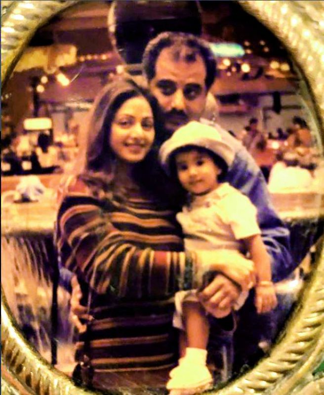The 21-year-old posted a childhood picture of her bundled up in her mother's arms, with her father Boney Kapoor standing behind them.