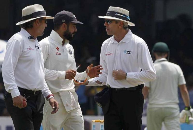 Virat Kohli protests with the umpires after Steve Smith attempted to take the help of the dressing room while going for a DRS referral, which is deemed illegal. (Photo: BCCI)