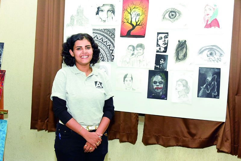 Nikita along with her paintings.