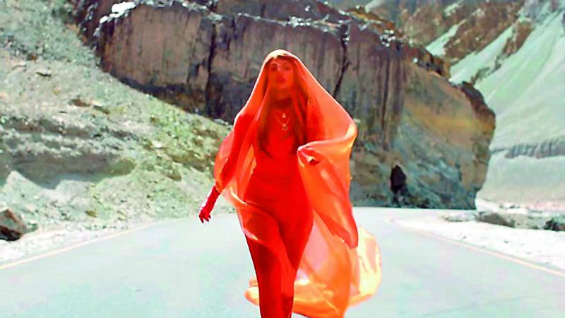 M.I.A. wearing an orange jumpsuit  styled by Indrakshi.