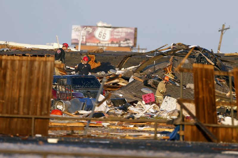 Workers look through tornado damage near the American Budget Value Inn in El Reno, Okla., Sunday, May 26, 2019. The deadly tornado leveled a motel and tore through the mobile home park near Oklahoma City overnight. (Bryan Terry/The Oklahoman via AP) 