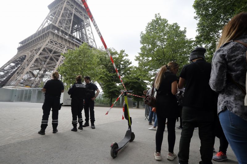 Police prevent tourists from entering the area of the Eiffel Tower Monday, May 20, 2019 in Paris. The Eiffel Tower has been closed to visitors after a person has tried to scale it. (AP Photo/Michel Euler) 