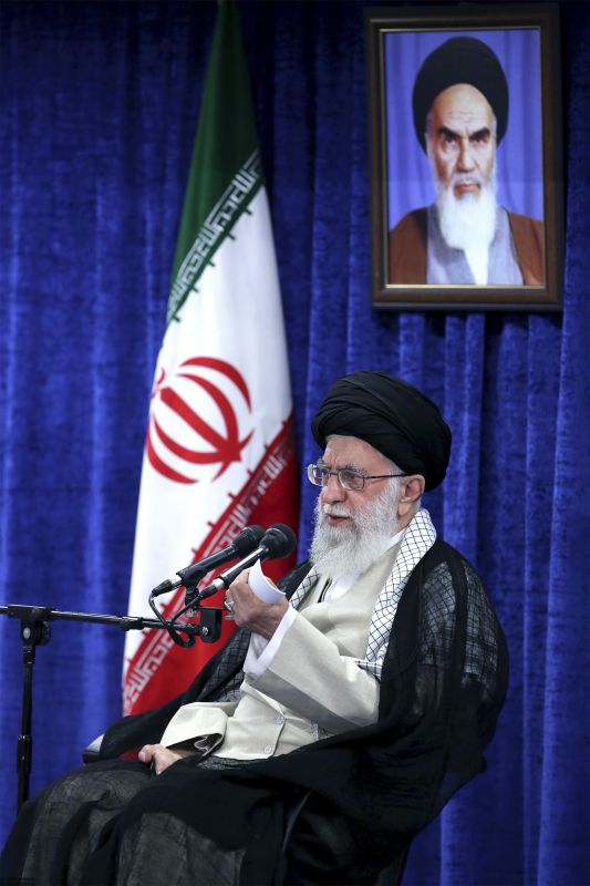 Supreme Leader Ayatollah Ali Khamenei speaks in a meeting with governmental officials in Tehran, Iran, Tuesday, May 14, 2019. Khamenei said his country won't negotiate with the United States and there will be no war between the two countries. A portrait of the late revolutionary founder Ayatollah Khomeini hangs at rear. (Office of the Iranian Supreme Leader via AP)
