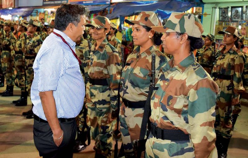 State Police Chief Loknath Behera interacts with lady commandos at Attukal temple in Thiruvananthapuram on Friday. (Photo: SABARI NATH. R)