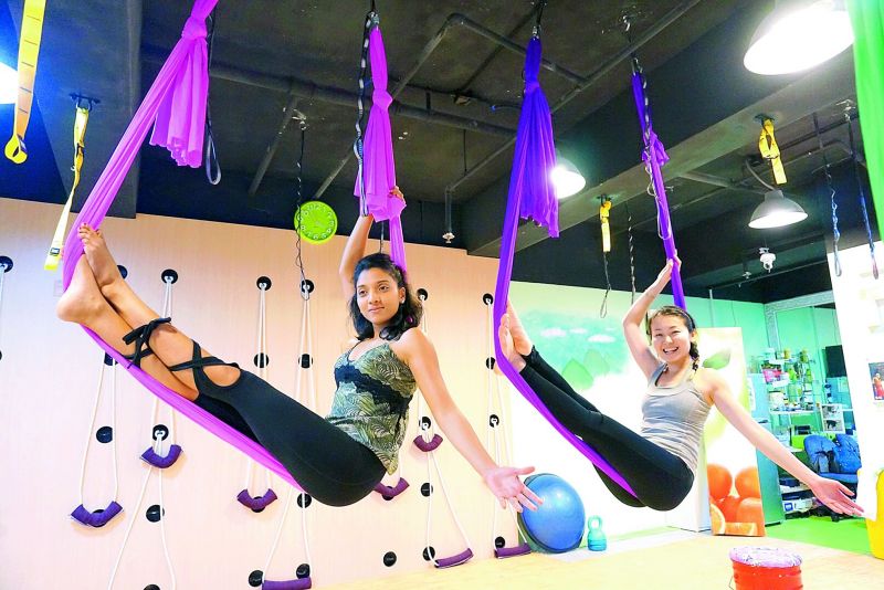 aerial yoga: Joshna Ramakrishnan (left), a yoga practitioner who trains people in China, performing an aerial yoga aasana