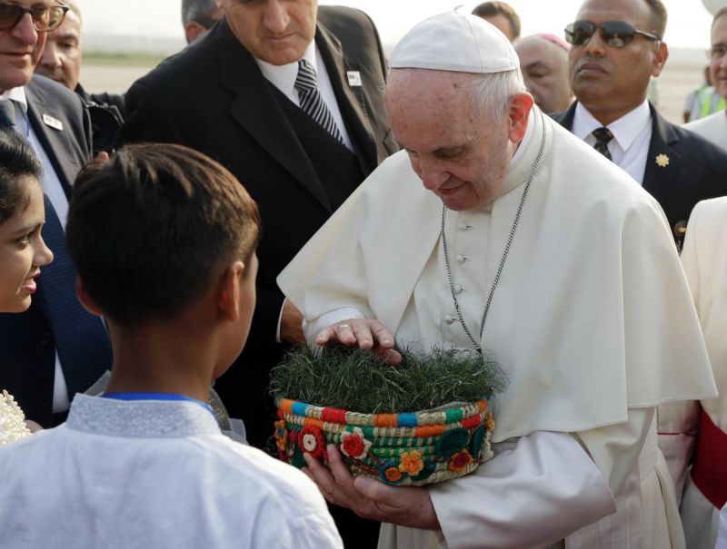 Pope Francis is offered a basket of Bangladesh soil as he arrives at Dhaka's international airport, Bangladesh. (Photo: AP)