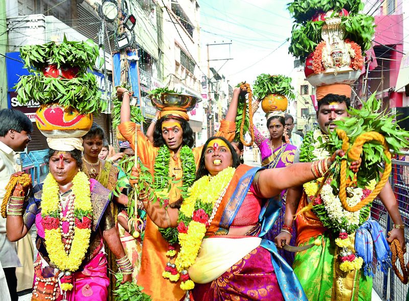 Devotees take out a procession carrying bonam (Above) to the Ujjaini Mahankali temple in Secunderabad on Sunday. (Photo: S. Surender Reddy)