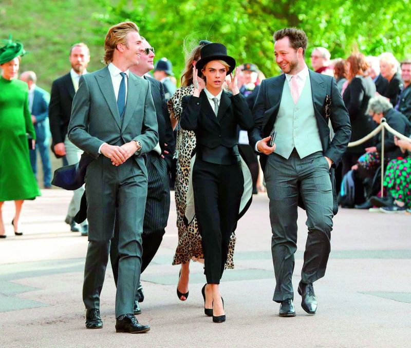 Cara Delevinge was seen rocking a tuxedo and a top hat for Princess Eugiene's royal wedding.