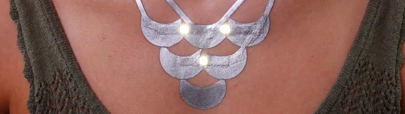 DuoSkin metal leaf traces serve both, decorative and functional purposes, this LED necklace is an example of jewelry-like routing made with DuoSkin. 