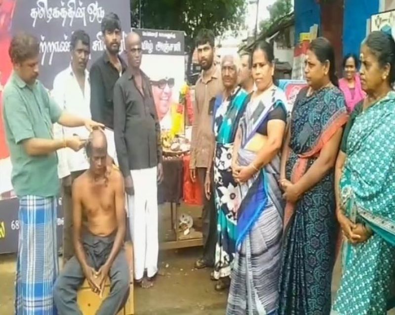 A DMK supporter in Coimbatore gets his head tonsured as mark of respect for Karunandhi. (Photo: Twitter | ANI)