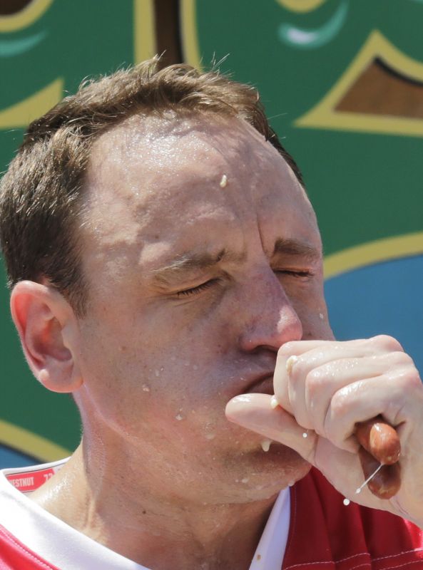 Joey Chestnut eats two hot dogs at a time during the Nathan's Annual Famous International Hot Dog Eating Contest, Tuesday July 4, 2017, in New York. Chestnut won, marking his 10th victory in the event. (AP Photo/Bebeto Matthews)