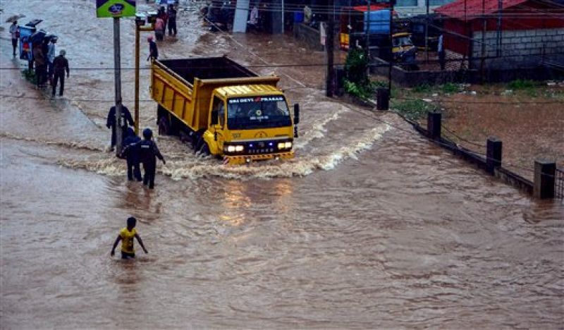 Rescuers at work in a flooded locality after a thunderstorm, in Mangaluru. (Photo: PTI)