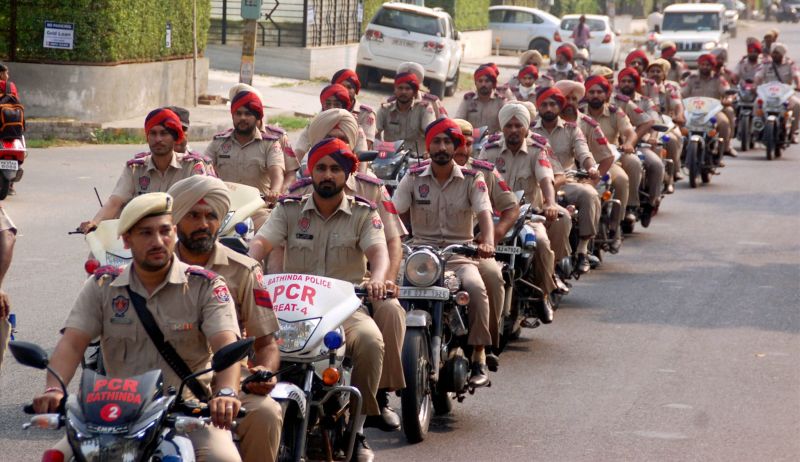 Police personnel march in a street in Bathinda on Monday. The securty has been beefed-up in the city in the view of the verdict in a case against Sirsa-based Dera Sacha Sauda chief Gurmit Ram Rahim Singh likely to be announced on August 25. (Photo: PTI)